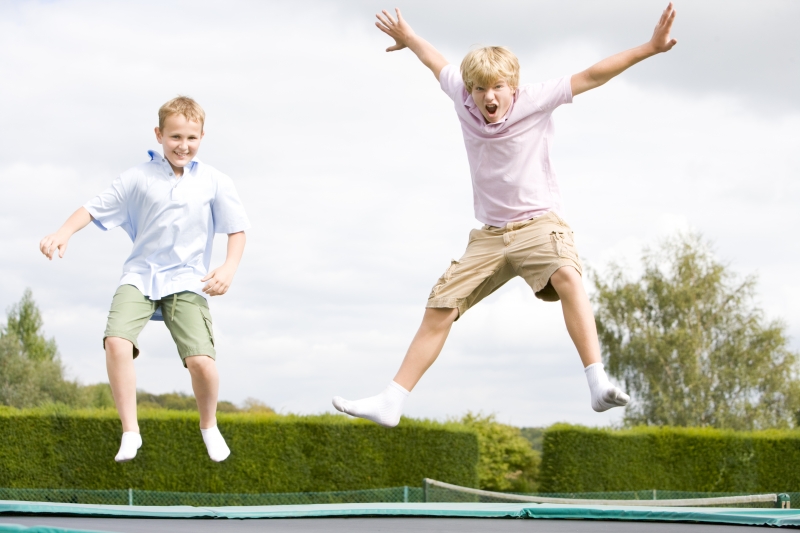 2165881-two-young-boys-jumping-on-trampoline-smiling